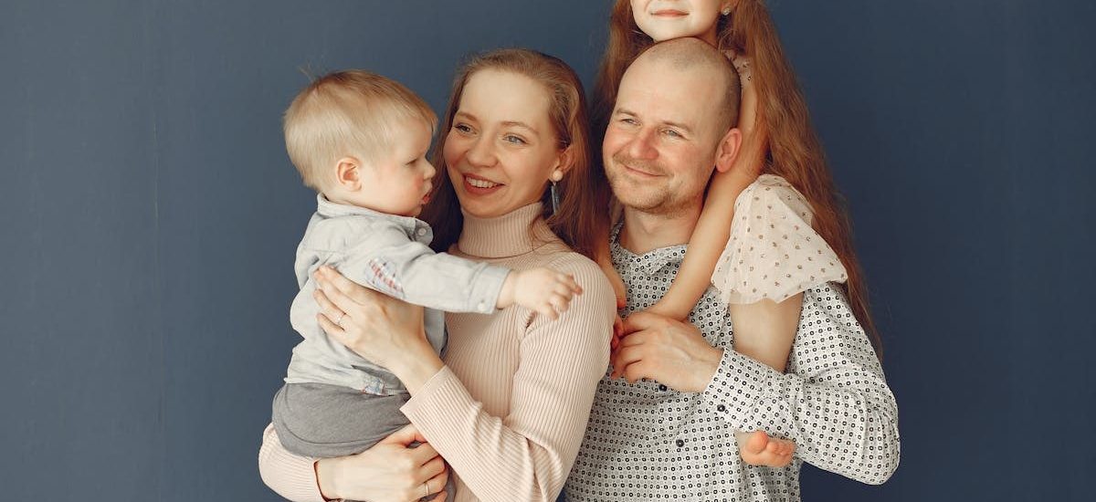 A joyful family portrait showcasing parents and their two children, expressing love and togetherness.