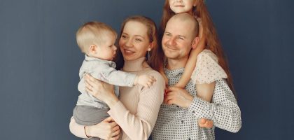 A joyful family portrait showcasing parents and their two children, expressing love and togetherness.