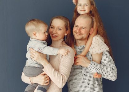 A joyful family portrait showcasing parents and their two children, expressing love and togetherness.